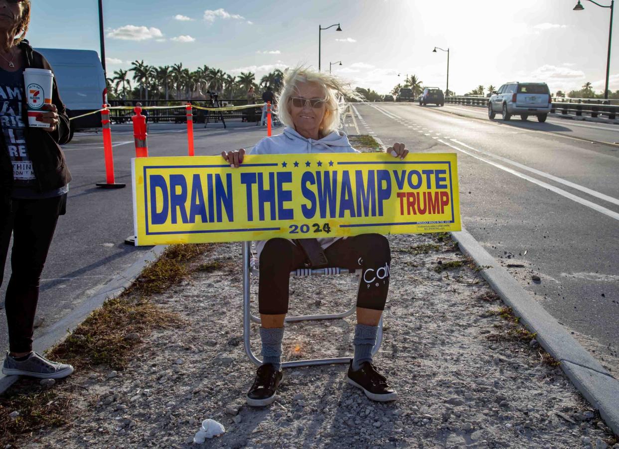 Elizabeth DePiero protests near Mar-a-Lago Friday, a day after a New York City grand jury voted to indict former President Donald Trump.