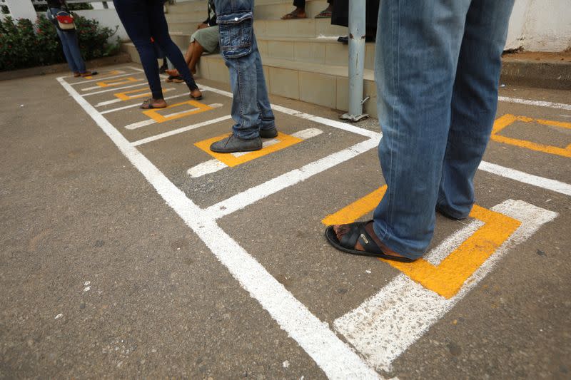 People stand within markings,as authorities ease the lockdown following the coronavirus disease (COVID-19) outbreak, in Abuja