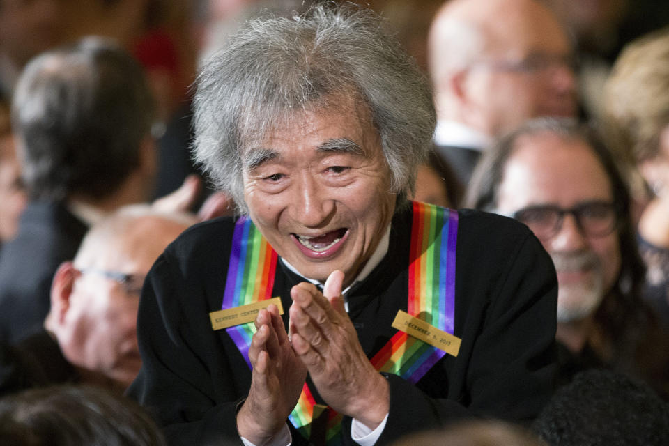 FILE - Conductor Seiji Ozawa stops to greet a young child in the audience as he arrives for a reception for himself and the other Kennedy Center Honors honorees in the East Room of the White House in Washington on Dec. 6, 2015. Japanese conductor Ozawa, who has music director for the Boston Symphony Orchestra, has died, his office said Friday, Feb. 9, 2024.(AP Photo/Andrew Harnik, File)