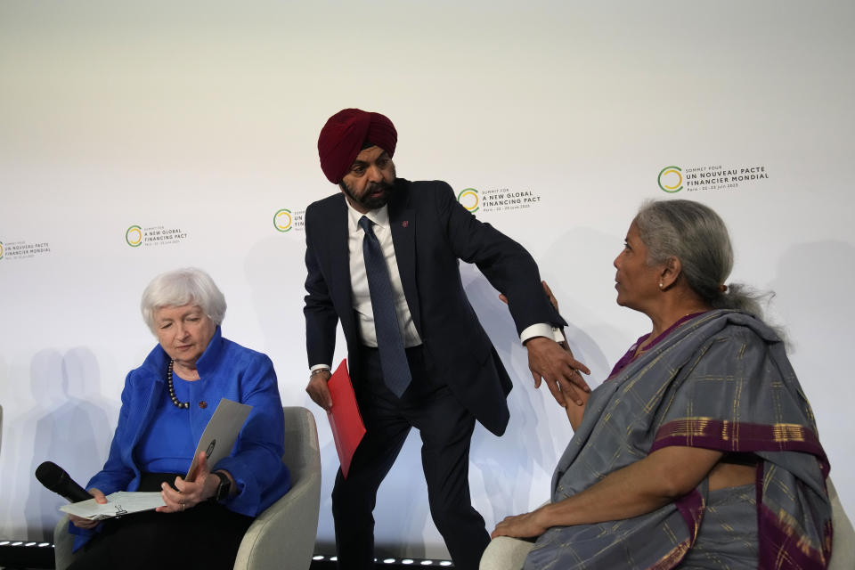 World Bank President Ajay Banga, center, gestures toward Indian Finance Minister Nirmala Sitharaman as U.S. Treasury Secretary Janet Yellen, left, reads a document, at the Global Climate Finance summit, Thursday, June 22, 2023 in Paris. World leaders, heads of international organizations and activists are gathering in Paris for a two-day summit aimed at seeking better responses to tackle poverty and climate change issues by reshaping the global financial system. (AP Photo/Christophe Ena)