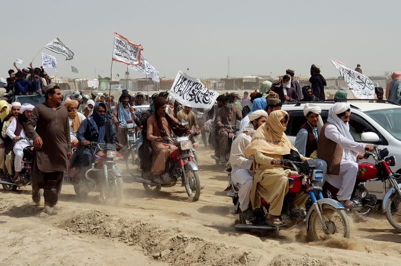 People on vehicles gather near Friendship Gate crossing on Pakistan-Afghanistan border, in Chaman