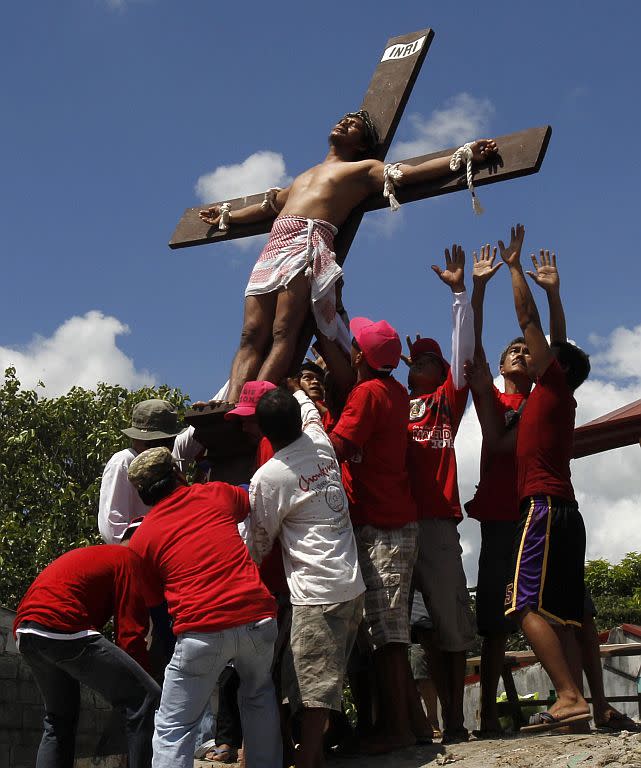 �Rolly Pantajo, 58, who portrays Jesus Christ, is laid down after he was nailed on a wooden cross during a Good Friday crucifixion re-enactment in San Juan village, Pampanga province, north of Manila.