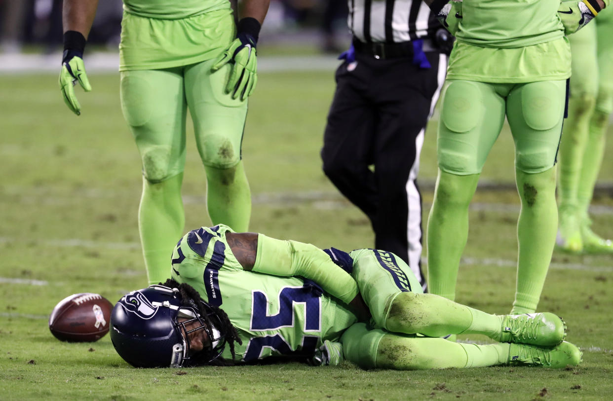 Richard Sherman lies injured on the turf during the second half of a “Thursday Night Football” game in November. Sherman suffered a season-ending leg injury. (AP)