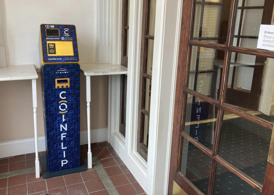 A CoinFlip cryptocurrency ATM is seen Monday, Nov. 28, 2022, inside the entrance to the Cheyenne, Wyo., headquarters of Tacen, a cryptocurrency exchange planned to launch in 2023. Wyoming has sought with several new laws to attract crypto-related businesses to the state and plans to keep doing so despite the industry's recent troubles. (AP Photo/Mead Gruver)