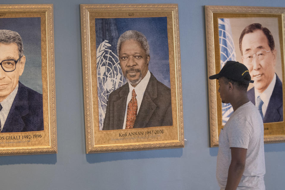 A visitor to the United Nations pauses in front of the portrait of former Secretary-General Kofi Annan at U.N. headquarters, Saturday, Aug. 18, 2018. Annan, one of the world's most celebrated diplomats and a charismatic symbol of the United Nations who rose through its ranks to become the first black African secretary-general, has died. He was 80. (AP Photo/Mary Altaffer)