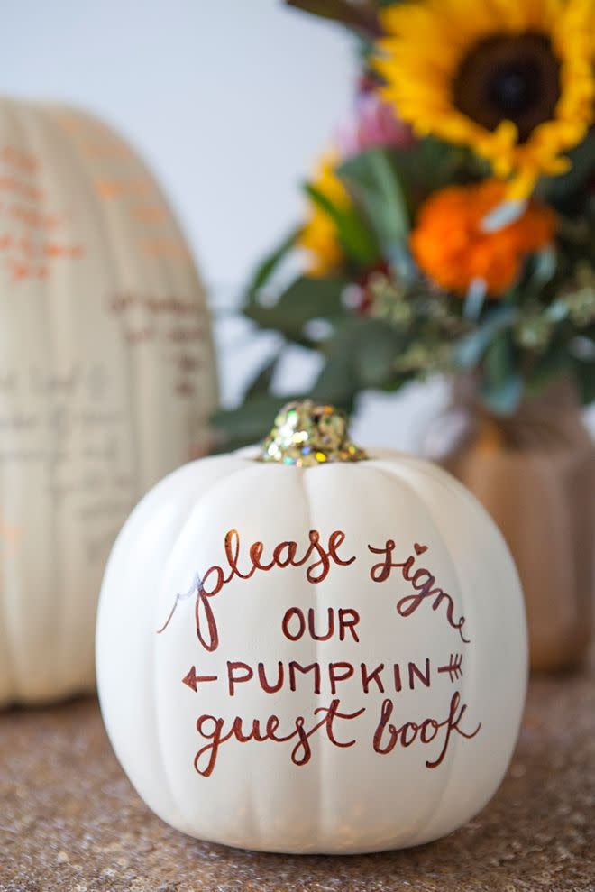 <p>This genius approach to pumpkin decorating is a keeper. Coat your pumpkin in white, give your party guests markers, and ask them to sign their names or write little messages as a memento. This is a great fall centerpiece for all of your <a href="https://www.womansday.com/food-recipes/food-drinks/g2575/halloween-dinner-ideas/" rel="nofollow noopener" target="_blank" data-ylk="slk:Halloween dinners" class="link ">Halloween dinners</a>, too!</p><p>Get the <strong><a href="http://somethingturquoise.com/2014/10/31/diy-faux-pumpkin-guest-book/" rel="nofollow noopener" target="_blank" data-ylk="slk:Faux Pumpkin Guest Book tutorial" class="link ">Faux Pumpkin Guest Book tutorial</a></strong> at Something Turquoise.<br></p><p>RELATED: <strong><a href="https://www.womansday.com/home/decorating/g269/thanksgiving-centerpieces/" rel="nofollow noopener" target="_blank" data-ylk="slk:30 Easy Thanksgiving Centerpieces That Will Make Your Table Shine" class="link ">30 Easy Thanksgiving Centerpieces That Will Make Your Table Shine</a></strong></p>