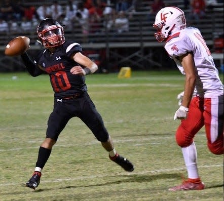 New Mexico Military's Juan Badillo attempts a pass against the Loving Falcons in 2021.