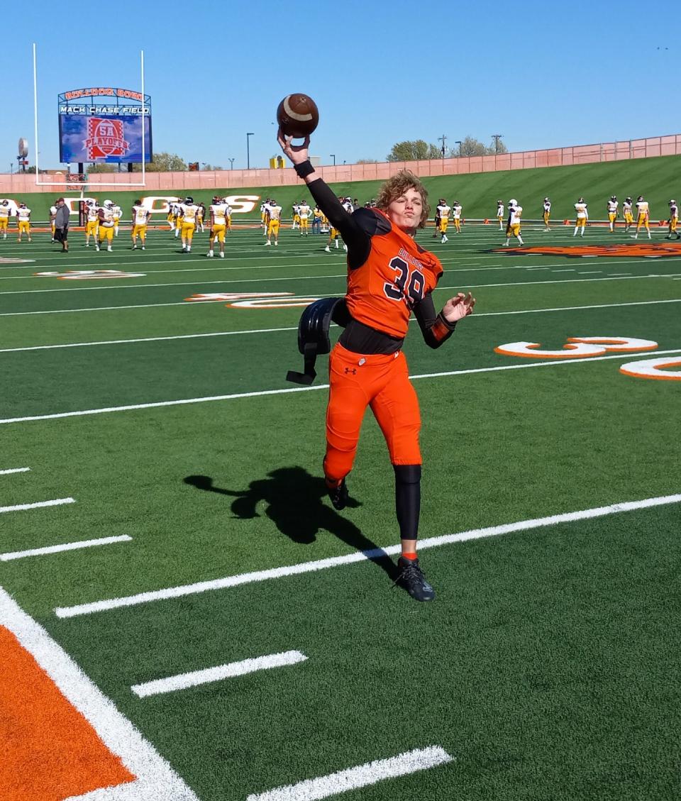 Artesia High School junior quarterback Nye Estrada warms up before the Nov. 12, 2022 playoff football game against Albuquerque Valley.