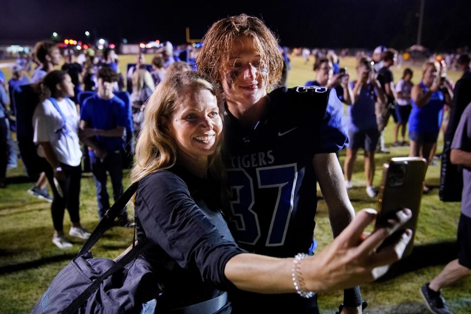 Waverly Central's Trey Maples (37) takes a picture with his mother, Amanda Maples, after defeating Camden Central at Waverly Central High School in Waverly, Tenn., Friday, Aug. 19, 2022.
