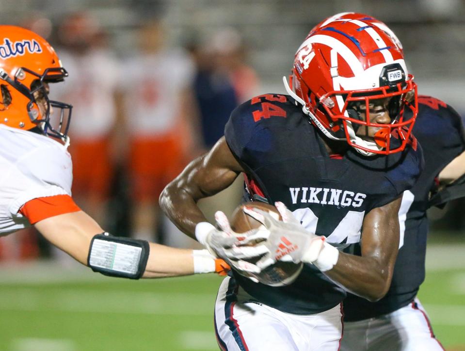 Nicklos Mctear carries the ball during the Fort Walton Beach Escambia football game played at Steve Riggs Stadium.