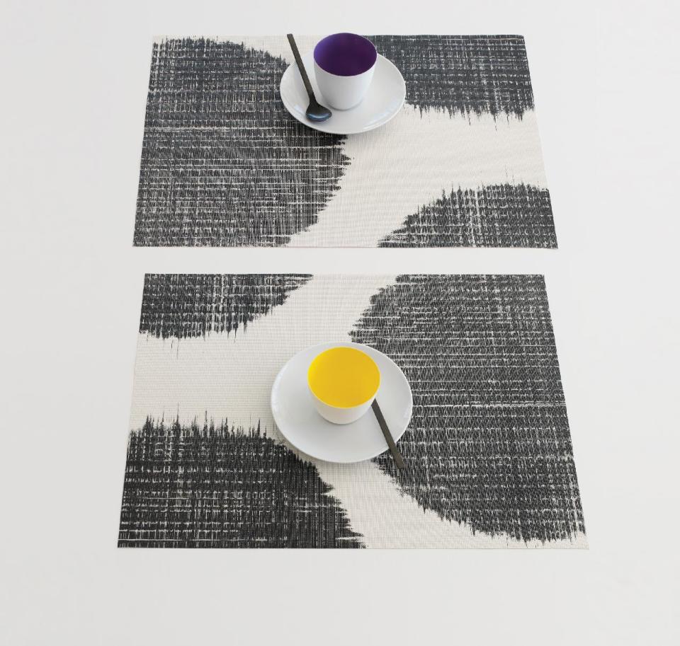 This undated publicity photo provided by Chilewich shows Sandy Chilewich’s new large scale abstract Brush Dot silkscreened design in black on her signature woven vinyl placemat (www.chilewich.com). (AP Photo/Chilewich, Victor Schrager Photography)