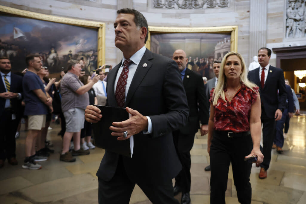 U.S. House Homeland Security Chairman Mark Green of Tennessee, foreground, Rep. Marjorie Taylor Greene of Georgia and their fellow Republican impeachment managers walk back through the U.S. Capitol Rotunda after transmitting articles of impeachment against Homeland Security Secretary Alejandro Mayorkas to the U.S. Senate on April 16, 2024.