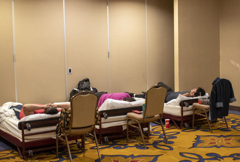 Residents of the Mescalero Apache Reservation rest while sheltering at the Inn of the Mountain Gods Resort in Ruidoso, N.M., Tuesday, June 18, 2024. Thousands of residents fled their homes as a wildfire swept into the mountain village of Ruidoso in southern New Mexico. (AP Photo/Andres Leighton)