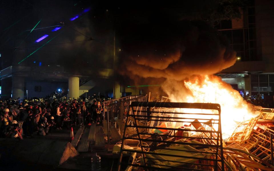 A fire caused by protesters and others is seen during a pro-democracy protest in Wan Chai on August 31 - AP
