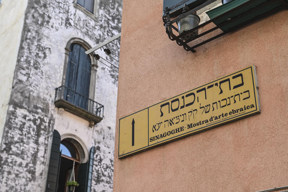 A sign in both Italian and Hebrew shows the way to the Jewish ghetto in Venice, northern Italy, Wednesday, June 1, 2022. Venice’s Jewish ghetto is considered the first in Europe and one of the first in the world, and a new effort is underway to preserve its 16th century synagogues for the Jews who have remained and tourists who pass through. (AP Photo/Chris Warde-Jones)