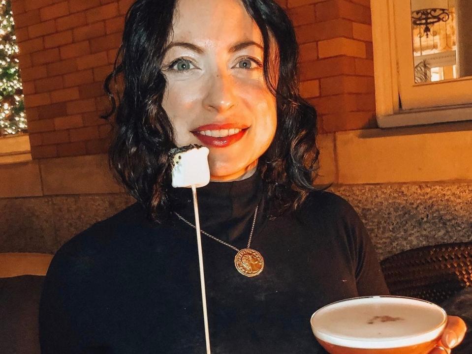 simone holding up a roasted marshmallow and a cocktail at the fairmount empress hotel