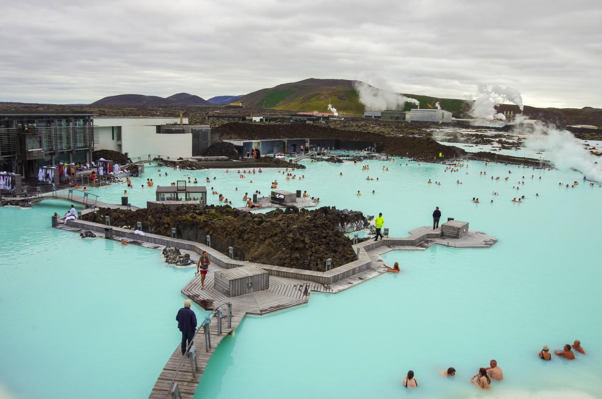 People bathing in The Blue Lagoon, a geothermal bath resort in the south of Iceland (Getty Images)