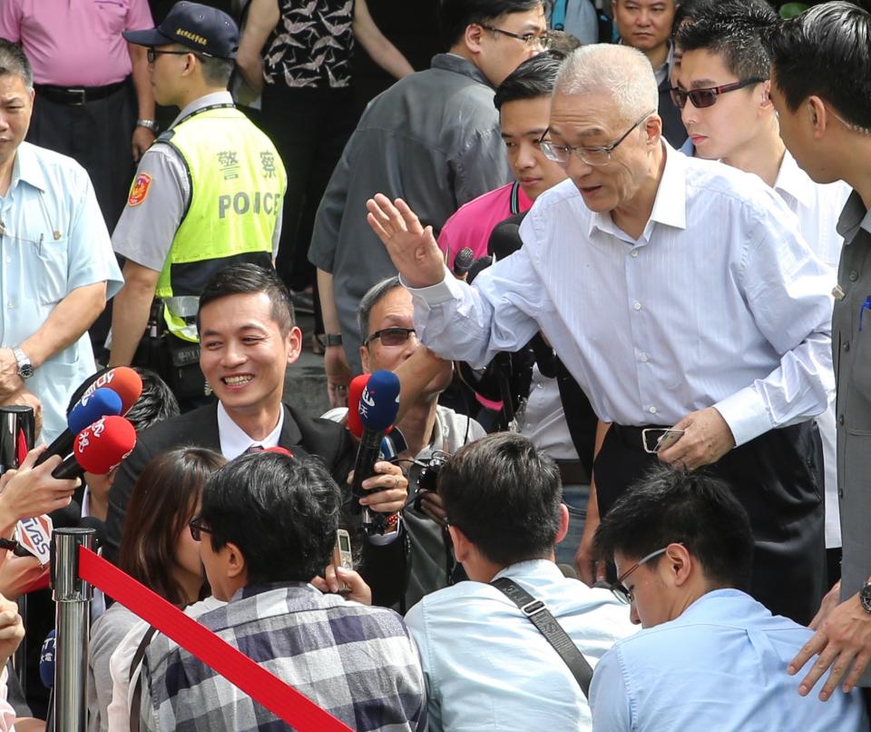 國民黨主席選舉20日投開票，國民黨主席候選人吳敦義 （前右）前往設在強恕中學的投票所投票後，向現場媒體致意。（中央社）