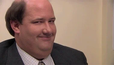 Brian Baumgartner, in character as Kevin Malone from "The Office," smirking and tilting his head slightly