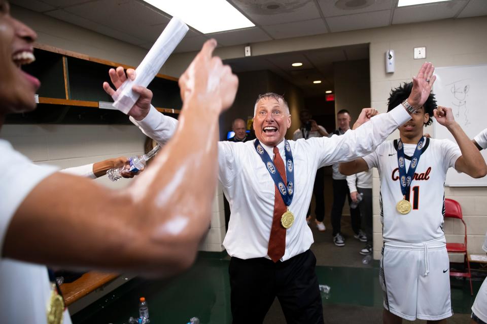 Central York head coach Jeff Hoke says two words - "state champs" - as he celebrates with his players after winning the PIAA Class 6A Boys Basketball Championship against Parkland at the Giant Center on March 23, 2024, in Hershey. The Panthers won, 53-51, to capture their first title in program history.