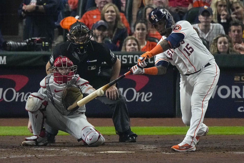 Houston Astros' Martin Maldonado hits hits an RBI single during the second inning in Game 1 of baseball's World Series between the Houston Astros and the Philadelphia Phillies on Friday, Oct. 28, 2022, in Houston. (AP Photo/Sue Ogrocki)