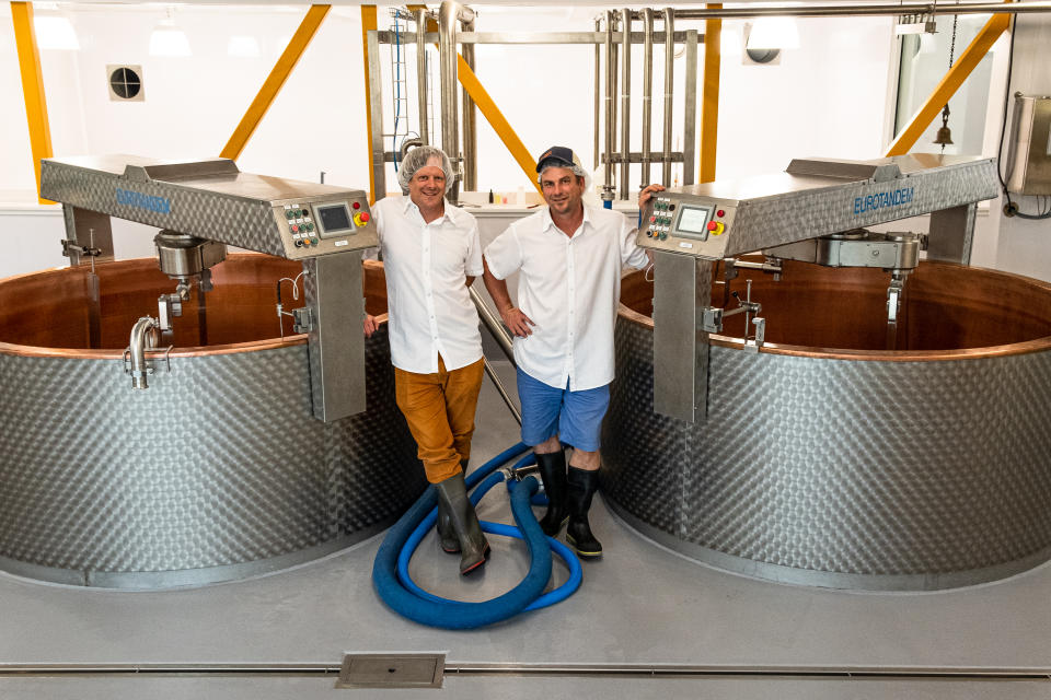 Andy Kehler, left, and Mateo Kehler next to their refurbished traditional cheese vats at Jasper Hill Farm. (Samuel Rheaume/Jasper Hill Farm)