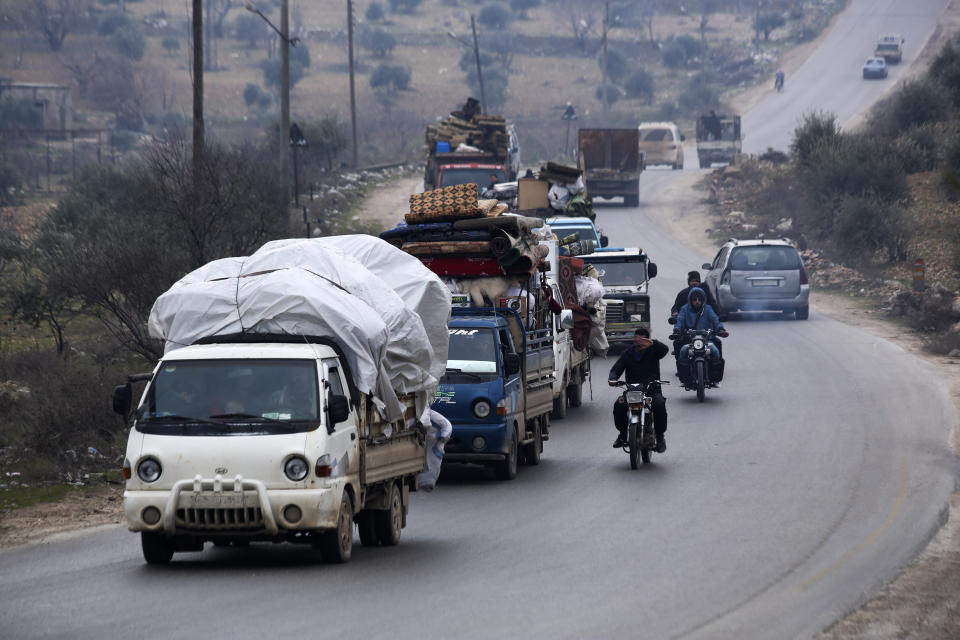 Syrians drive through the city of al-Mastouma, in Idlib province, as they flee a government offensive, Tuesday, Jan. 28, 2020. Syrian government forces have been on the offensive for more than a month in the northwestern Idlib province, the last rebel stronghold in the country. But in recent days, the government captured more than a dozen villages in the area as the insurgents' defenses began to crumble. (AP Photo/Ghaith Alsayed)