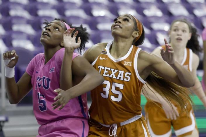 Texas forward Charli Collier (35) battles TCU forward Yummy Morris (5) for position as Texas guard Audrey Warren (31) looks on during the first half of an NCAA college basketball game, Sunday, March 7, 2021, in Fort Worth, Texas. (AP Photo/Ron Jenkins)