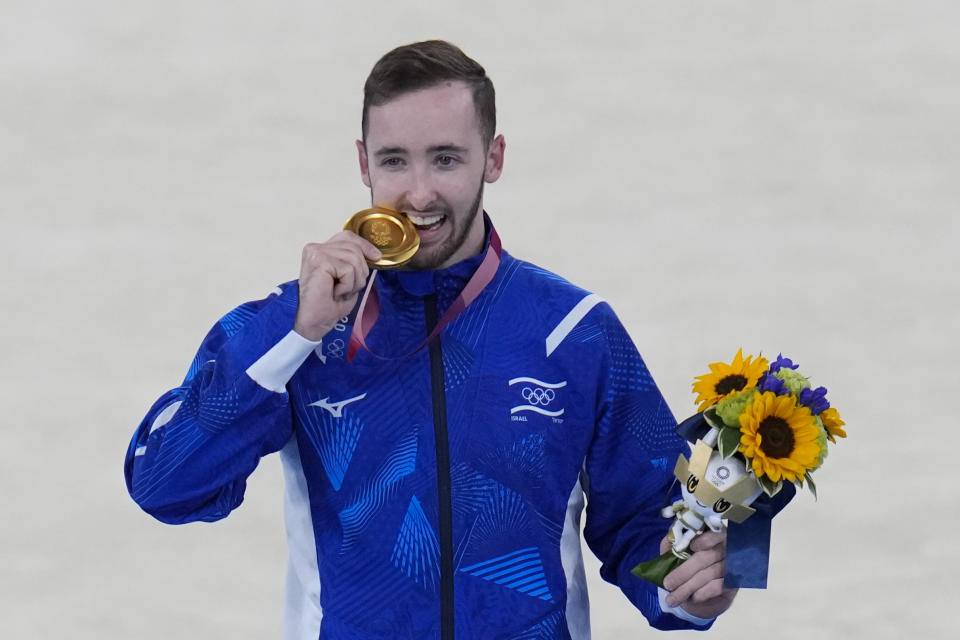 Artem Dolgopyat of Israel, poses after winning the gold medal on the floor exercise during the artistic gymnastics men's apparatus final at the 2020 Summer Olympics, Sunday, Aug. 1, 2021, in Tokyo, Japan. (AP Photo/Gregory Bull)