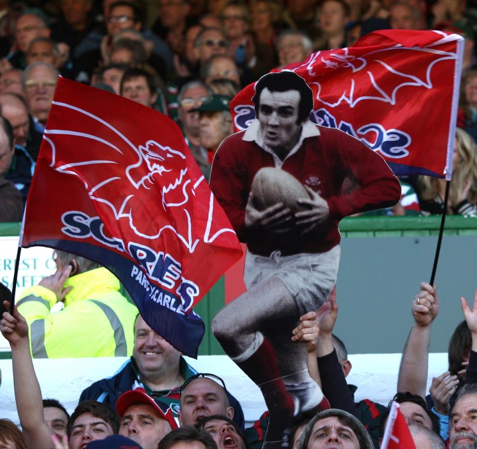 Scarlets fans hold up a cardboard cut-out of Phil Bennett (David Davies/PA). (PA Archive)