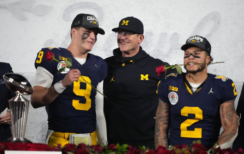 Michigan coach Jim Harbaugh, center, celebrates with quarterback J.J. McCarthy (9) and running back Blake Corum after defeating Alabama in their College Football Playoff semifinal game at the 2024 Rose Bowl.