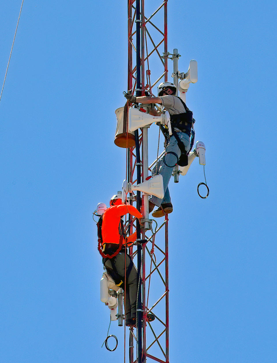 Tower technician install broadband transmitters on a  radio tower on the western edge of Emporia, Kansas in September 2022. (Mark Reinstein / MediaPunch/IPx via AP)