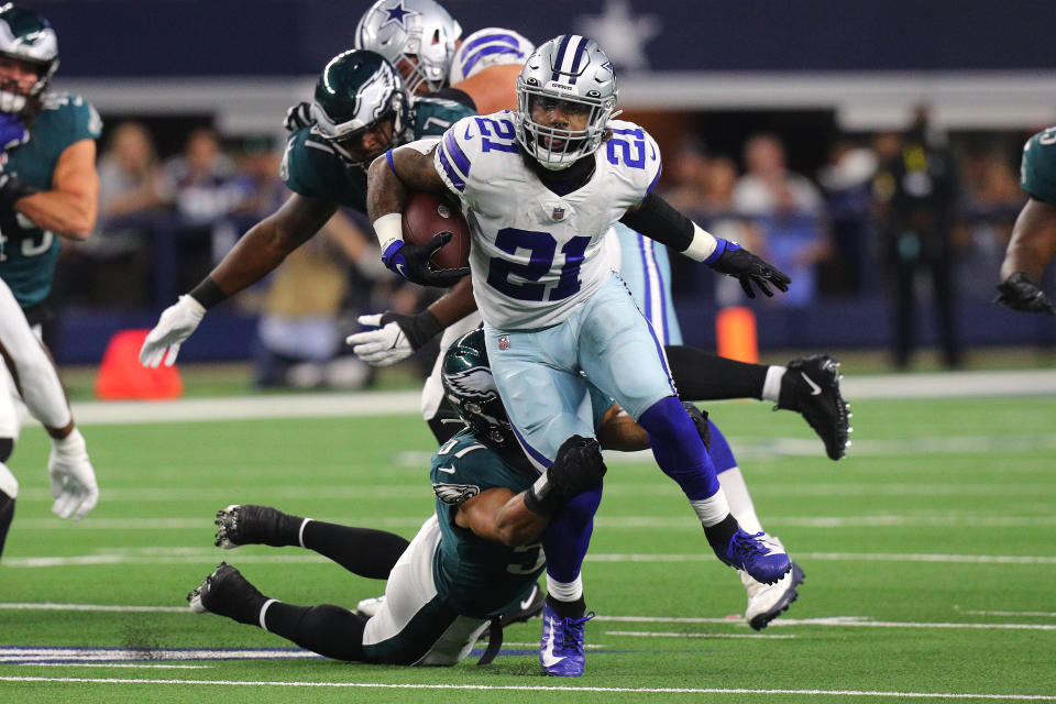 ARLINGTON, TEXAS - SEPTEMBER 27: Ezekiel Elliott #21 of the Dallas Cowboys tries to escape the tackle of T.J. Edwards #57 of the Philadelphia Eagles during a first quarter run at AT&T Stadium on September 27, 2021 in Arlington, Texas. (Photo by Richard Rodriguez/Getty Images)