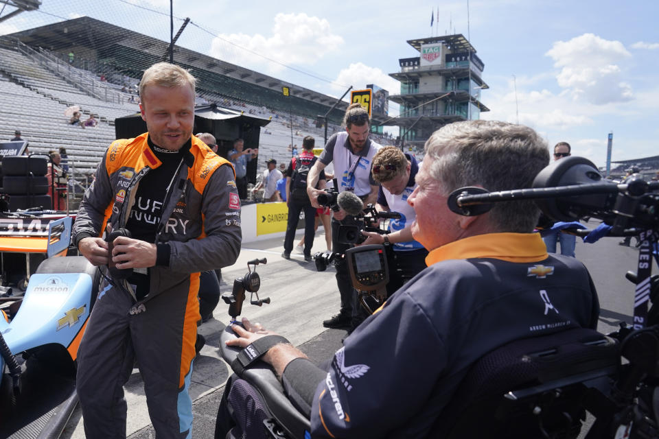 Felix Rosenqvist, of Sweden, talks with Sam Schmidt before a IndyCar auto race at Indianapolis Motor Speedway, Saturday, July 30, 2022, in Indianapolis. (AP Photo/Darron Cummings)