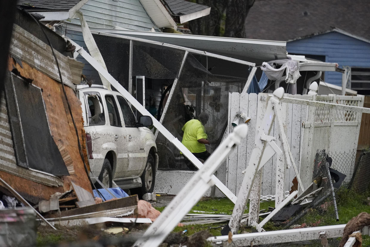 A person walks through a heavily damaged home after a tornado tore through the area in Killona, La., about 30 miles west of New Orleans in St. James Parish, Wednesday, Dec. 14, 2022. (AP Photo/Gerald Herbert)