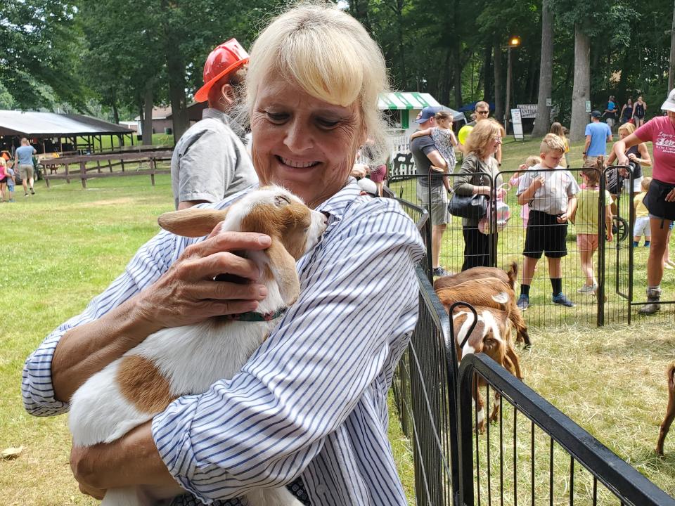 Robin Simard of Farmington was so taken by a baby goat that she is now considering getting goats of her own. She had many questions for Dotty Thompson, owner of Legacy Hill Farm during the Stratham 4-H Summerfest at Stratham Hill Park Saturday, July 16, 2022.