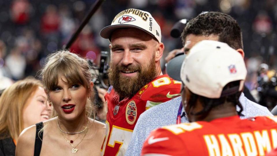 Travis Kelce (centre) with his girlfriend Taylor Swift after the Kansas City Chiefs won the Super Bowl earlier this year