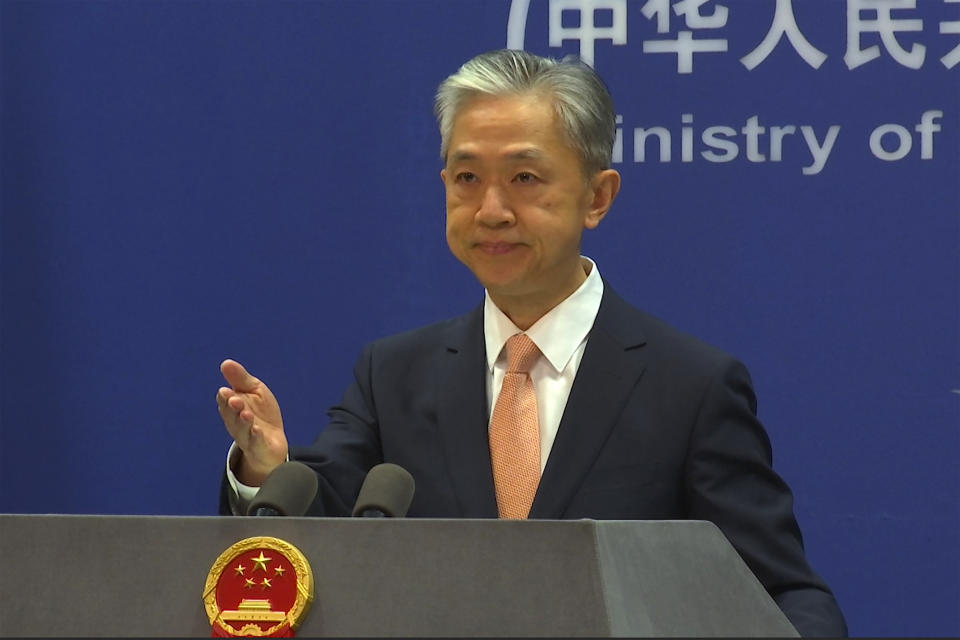 Chinese Foreign Ministry spokesperson Wang Wenbin reacts during the daily presser at the Ministry of Foreign Affiairs in Beijing, Friday, May 27, 2022. China on Friday criticized a speech by U.S. Secretary of State Antony Blinken focused on relations between the world's top two economic powers, saying the U.S. was seeking to smear Beijing's reputation. (AP Photo/Liu Zheng)