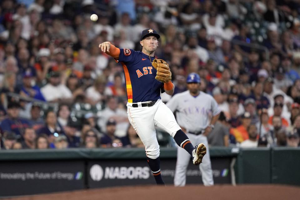 Houston Astros third baseman Alex Bregman throws to first for the out after fielding a ground ball by Texas Rangers' Leody Taveras during the third inning of a baseball game Sunday, April 16, 2023, in Houston. (AP Photo/David J. Phillip)