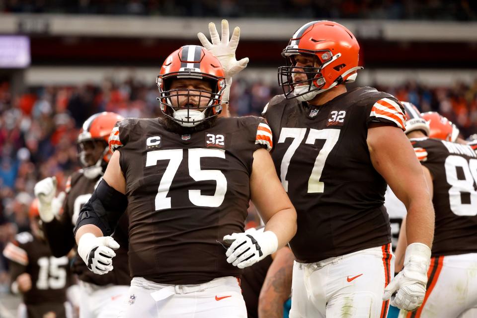 Cleveland Browns guard Joel Bitonio (75) and guard Wyatt Teller (77) react after a touchdown against the Jacksonville Jaguars on Dec. 10, 2023, in Cleveland.