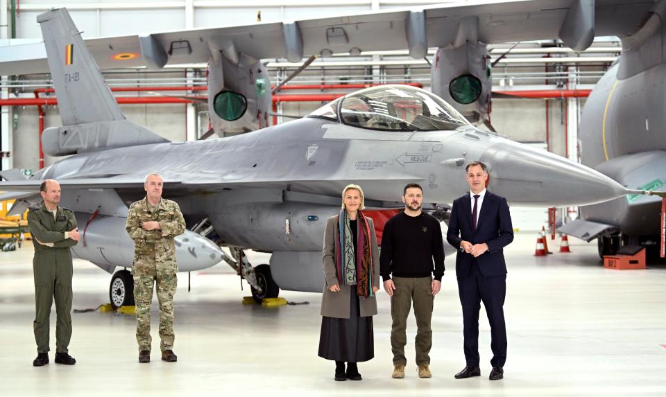 Ukrainian President Volodymyr Zelensky poses in front of an F-16 with Belgian Prime Minister Alexander De Croo and Belgian Minister of Defense Ludivine Dedonder during a visit to Belgium on May 28, 2024. <em>Photo by Didier Lebrun / Photonews via Getty Images</em>