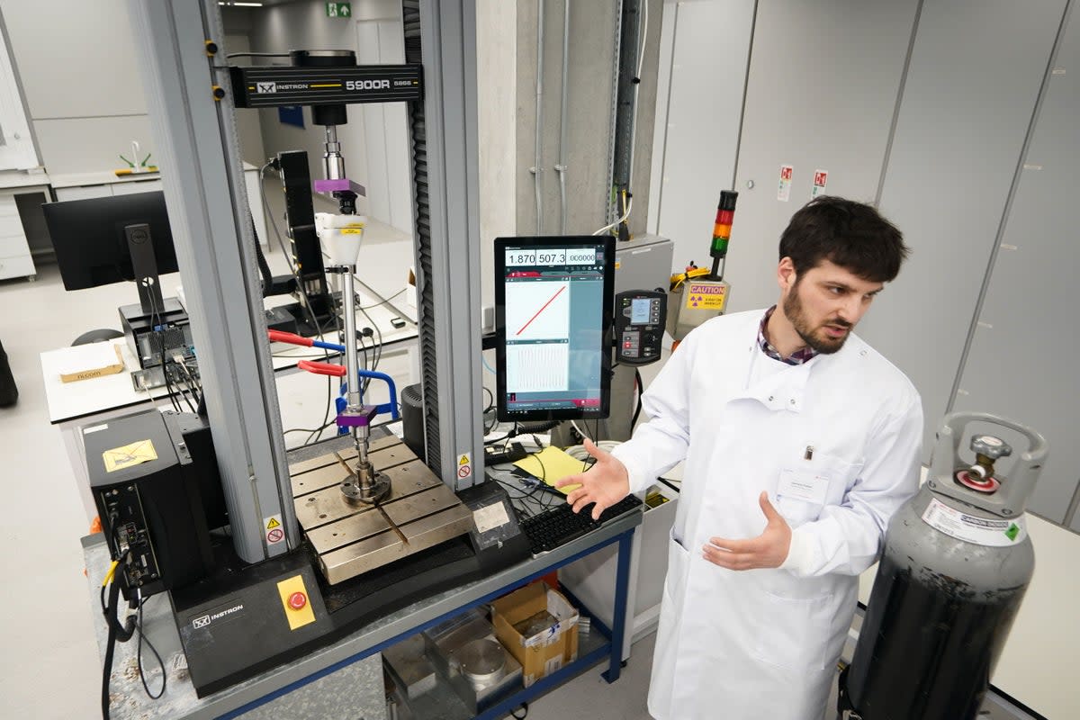 A researcher demonstrates a machine used to stress test prosthetics during the launch of the world’s first hub for child blast injury research (James Manning/PA) (PA Wire)