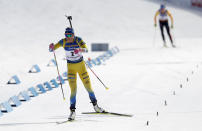 FILE - Sweden's Hanna Oberg crosses the finish line to finish second in the women's Biathlon World Cup 12.5 km mass start event in Nove Mesto na Morave, Czech Republic, March 8, 2020. Öberg took gold in the women's 15-kilometer individual at the PyeongChang Olympics, while Norway's Johannes Thingnes Boe won the men's race and both have stood on the podium this season. But all other 2018 gold-medal winners have moved on to other adventures. (AP Photo/Petr David Josek, File)