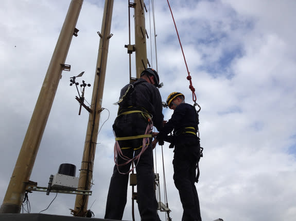 Gregory Schneider prepares to climb up the exterior of the Space Needle's mast in Seattle on May 9, 2012. Schneider won a free trip to suborbital space in the Space Race 2012 contest, a prize valued at $110,000.