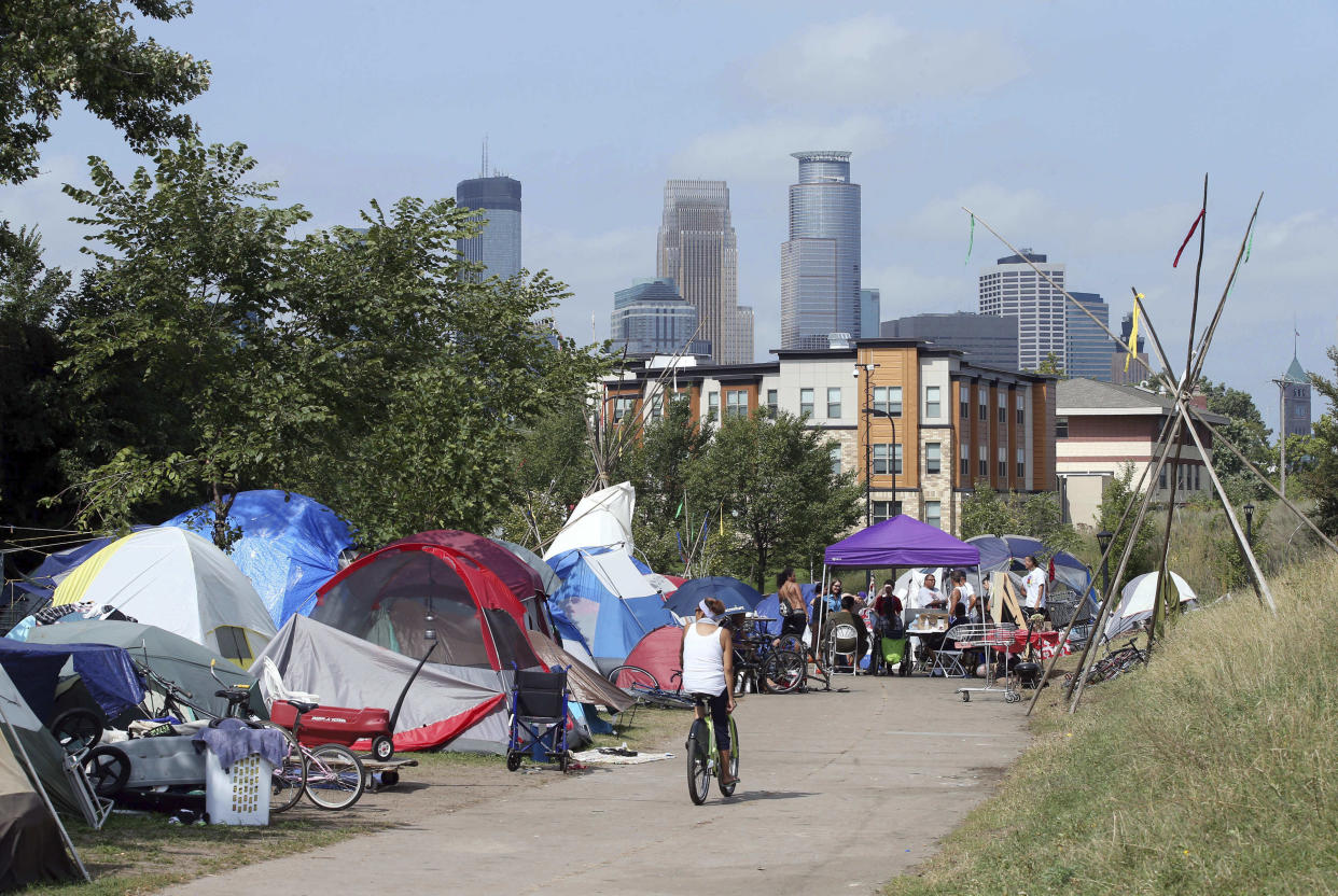 In this Sept. 14, 2018 photo, the skyline rises behind a homeless encampment in south Minneapolis.&nbsp; (Photo: ASSOCIATED PRESS)