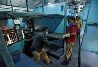 Workers remove berths from a passenger train to install as beds to set up an isolation facility in the train amid concerns about the spread of coronavirus disease (COVID-19), in Chennai