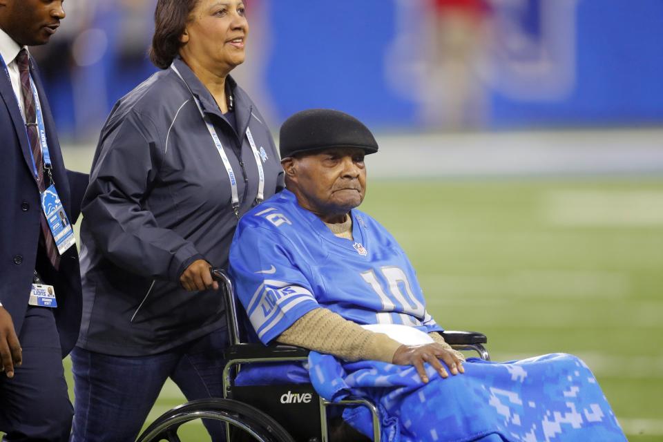 FILE - In this Nov. 12, 2017, file photo, Wally Triplett, a member of the 1949 Detroit Lions, is wheeled onto the field before an NFL football game between the Lions and the Cleveland Browns in Detroit. Triplett, who left his indelible mark on NFL history by becoming the first African-American player to be drafted and play for an NFL team, passed away Thursday, Nov. 8, 2018, the Detroit Lions announced. He was 92. (AP Photo/Paul Sancya, File)