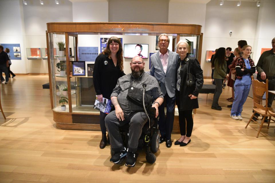 Curators of the "Hey buddy, I'm Bill" exhibit at the University of Iowa, Jen Knights and Brad Ferrier, pose with Barry and Bev Morrow, two of Sackter's best buddies.