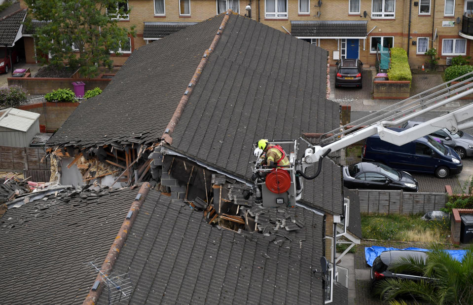 BOW, ENGLAND - JULY 08: Emergency crews at the scene where a 20-metre crane collapsed on onto a terraced house in East London on July 8, 2020 in Bow, England. The London Fire Brigade are working to rescue people trapped in a terraced house after a 20-meter crane on a nearby building site has collapsed. (Photo by Chris J Ratcliffe/Getty Images)