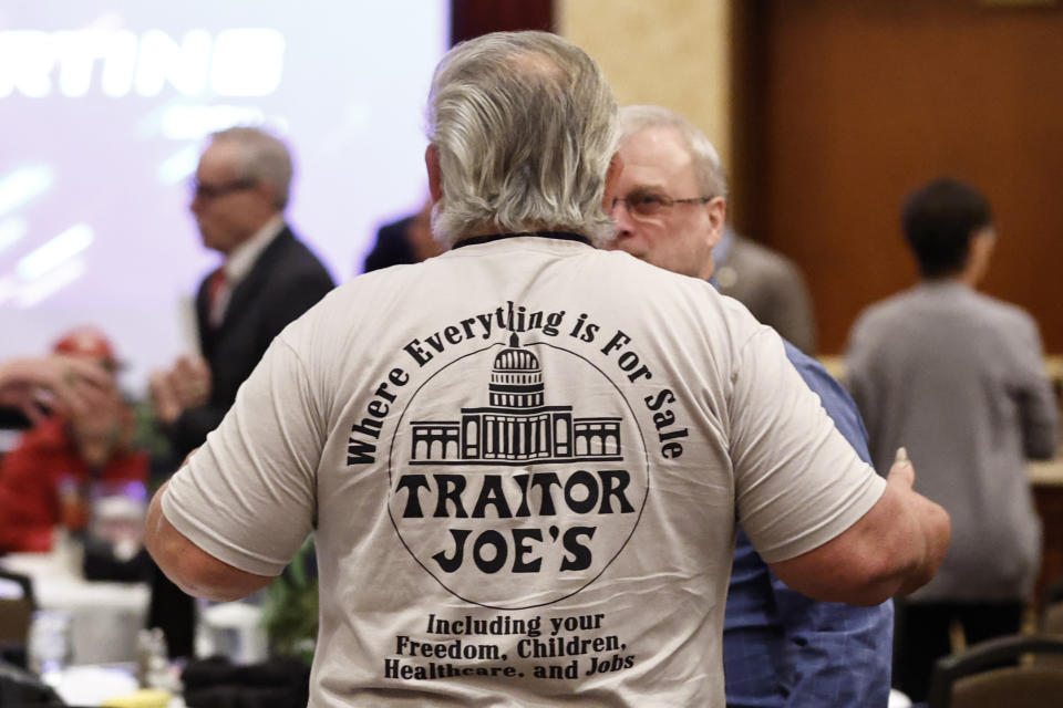 A participant wearing a shirt mocking President Joe Biden is seen before an Election Conspiracy Forum Saturday, March 11, 2023, in Franklin, Tenn. (AP Photo/Wade Payne)